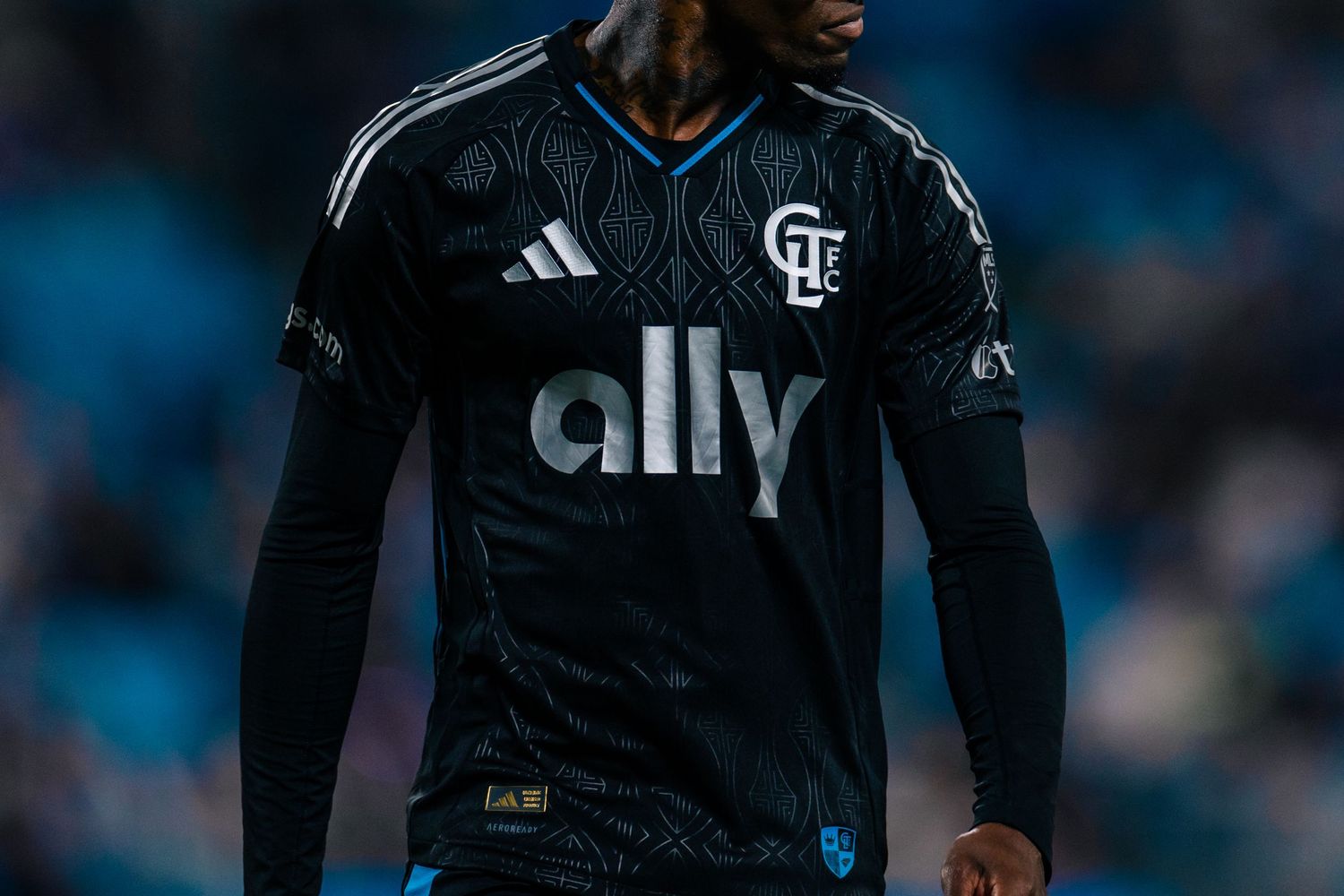 Charlotte FC player in black Adidas ally away jersey during an MLS soccer game.