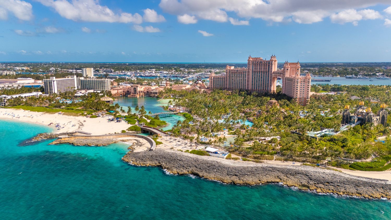 Aerial view of Atlantis Paradise Island resort in the Bahamas with turquoise waters and lush tropical landscaping.
