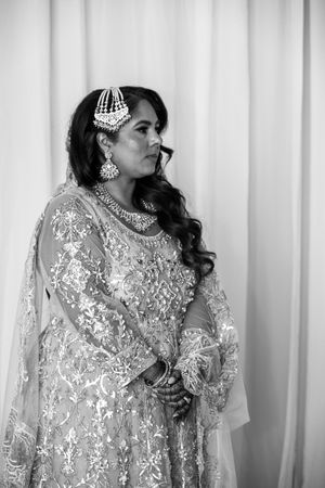 A bride in a shimmering white sequined gown and headpiece poses against a light backdrop in three elegant poses.