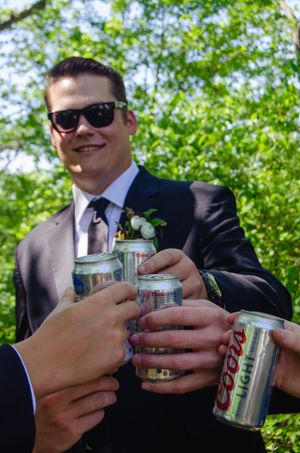 Wedding party toasting with Coors Light cans during pre-ceremony celebrations.