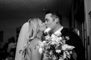 Romantic black and white portrait of newlyweds with bouquet.