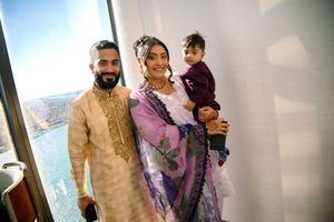 Wedding guests pose together in traditional Indian attire at an elegant celebration.