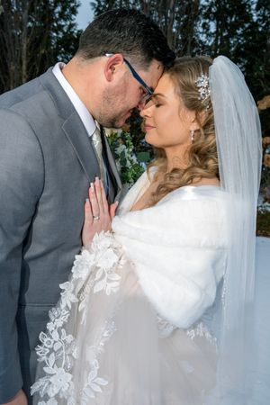A romantic sequence of wedding photos showing a couple in gray suit and white dress sharing tender moments under trees.
