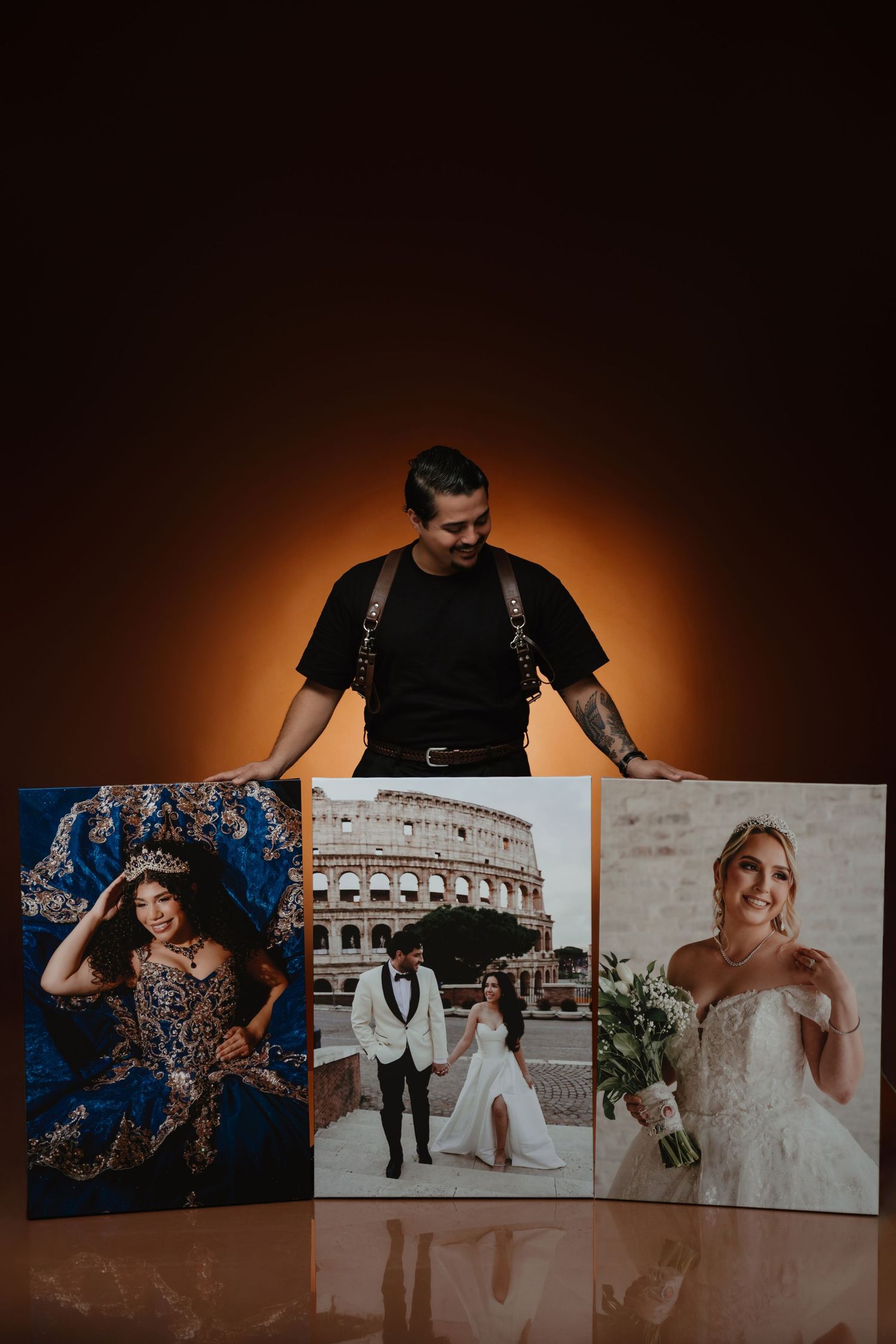 Photographer proudly displaying three large canvas prints of quinceañera and wedding portraits.