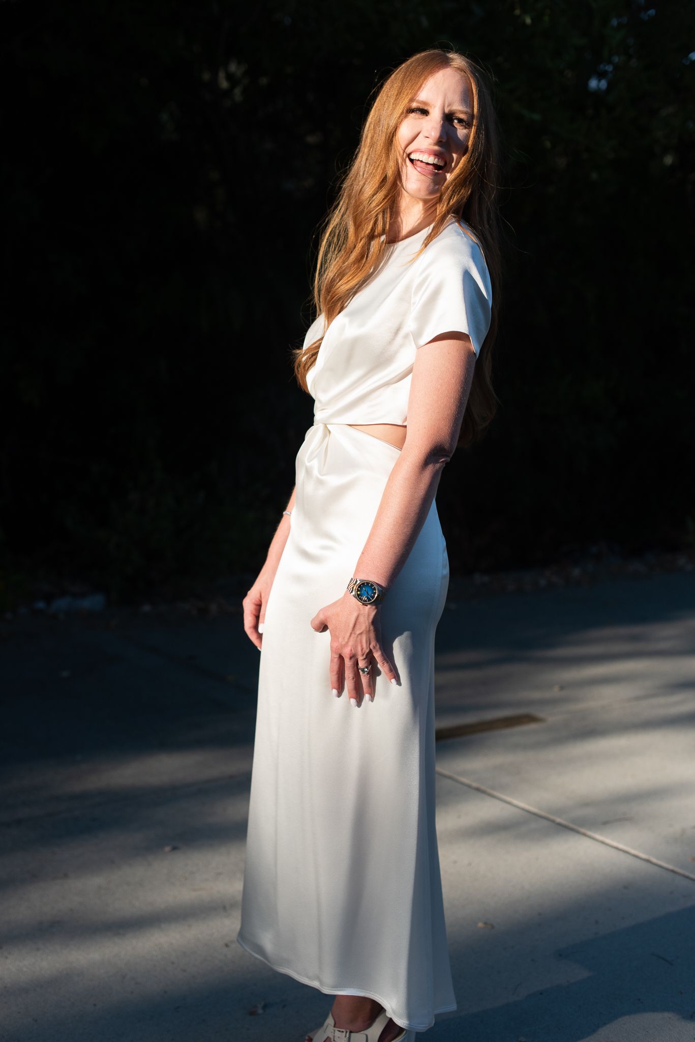 a bride laughing in a white dress