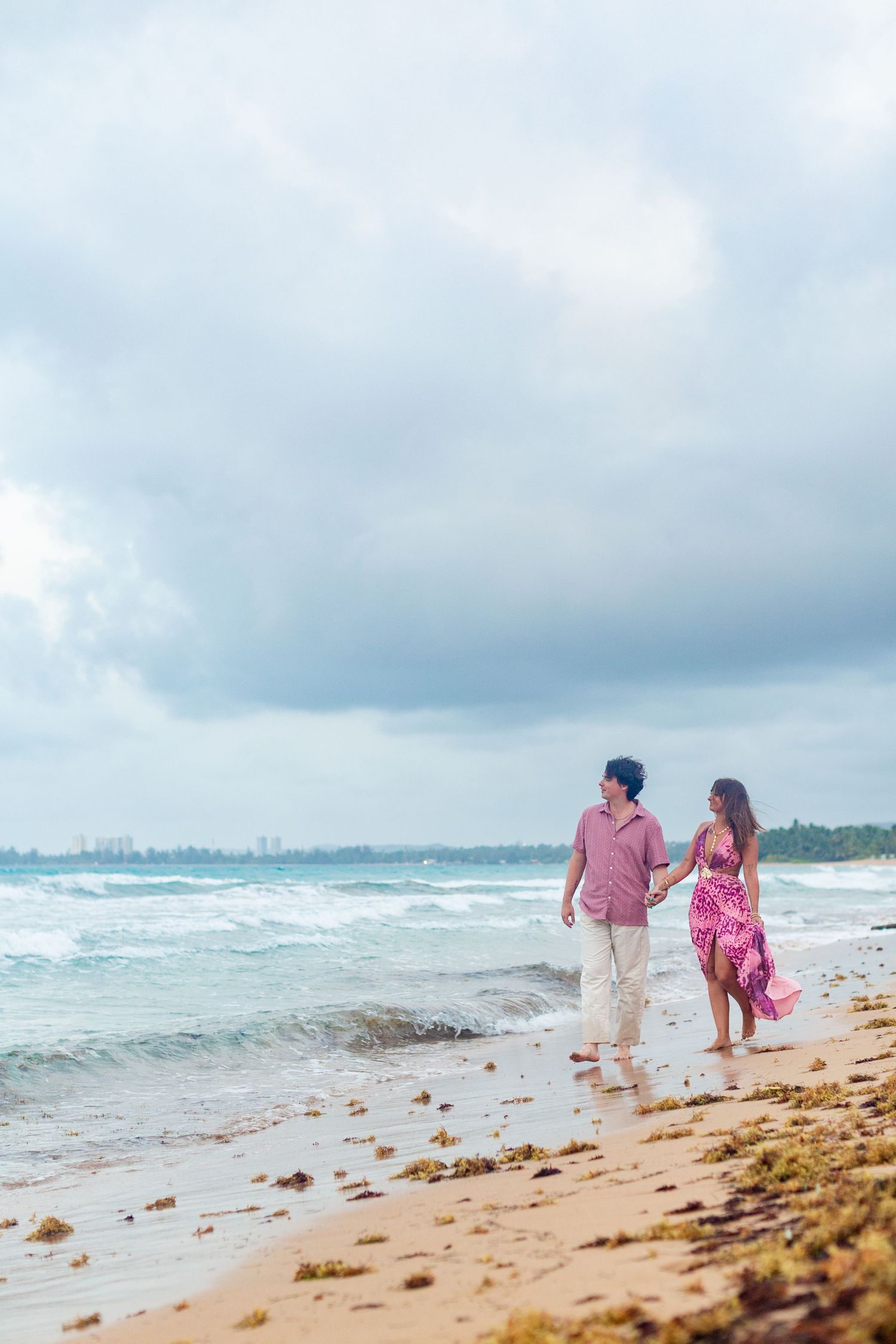 Couples portrait on the beach. Walking at the water's edge. Río Grande, Puerto Rico.