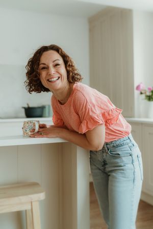 Candid sequence showing joyful expressions in a bright modern kitchen setting.