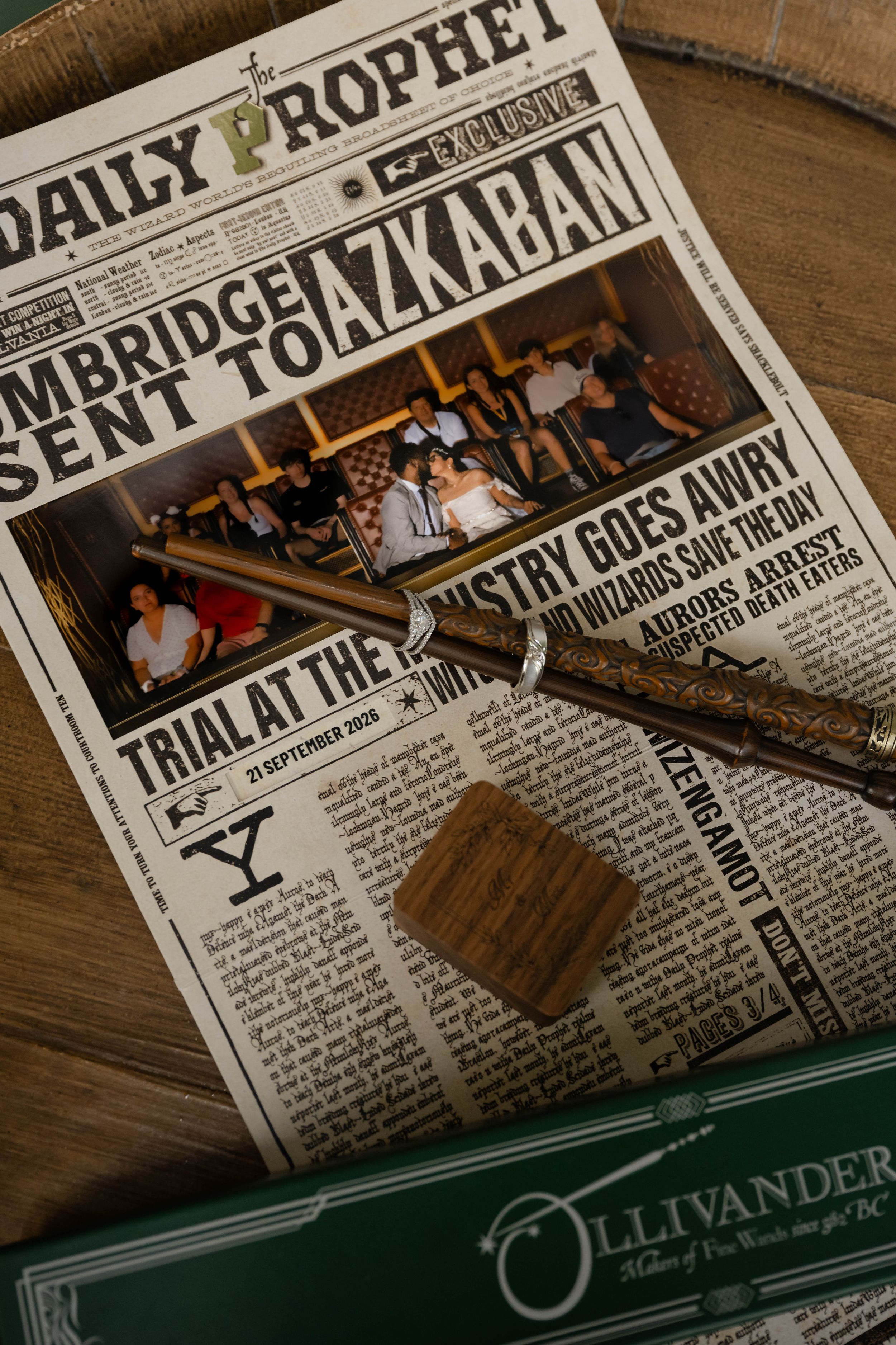 Daily Prophet newspaper from Harry Potter with a wand and Ollivanders box on a wooden table. Epic Universe.