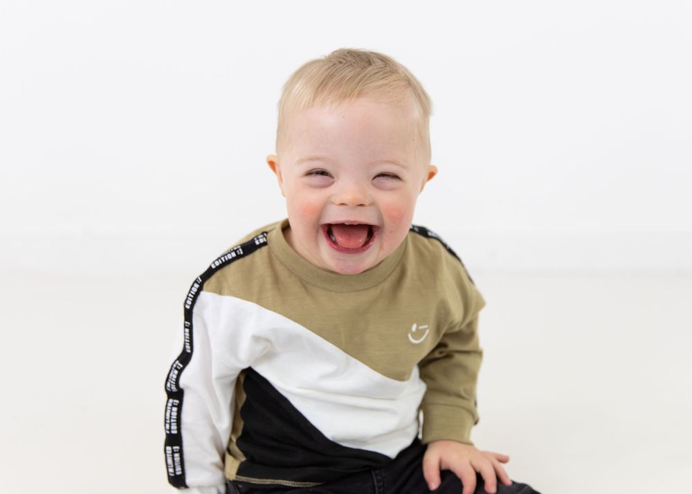 Series of progressive photos showing a happy baby in casual clothing.