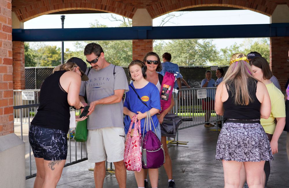 People gather under covered pavilion during community event.
