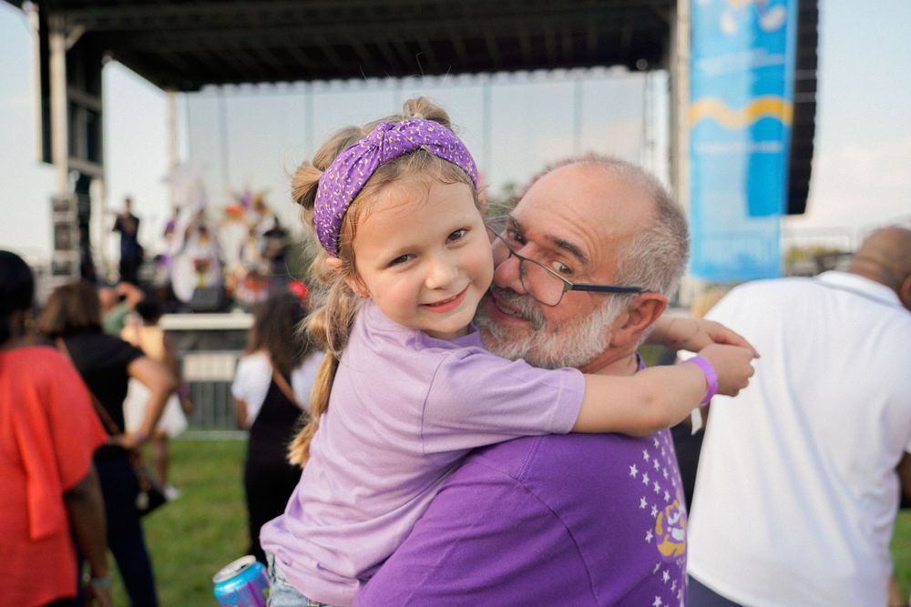 Heartwarming embrace shared at outdoor community festival.