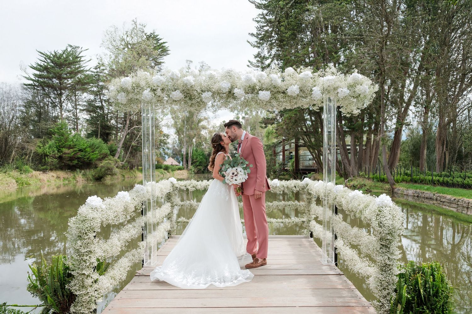 Romantic garden walkway decorated with white flowers for a wedding ceremony.