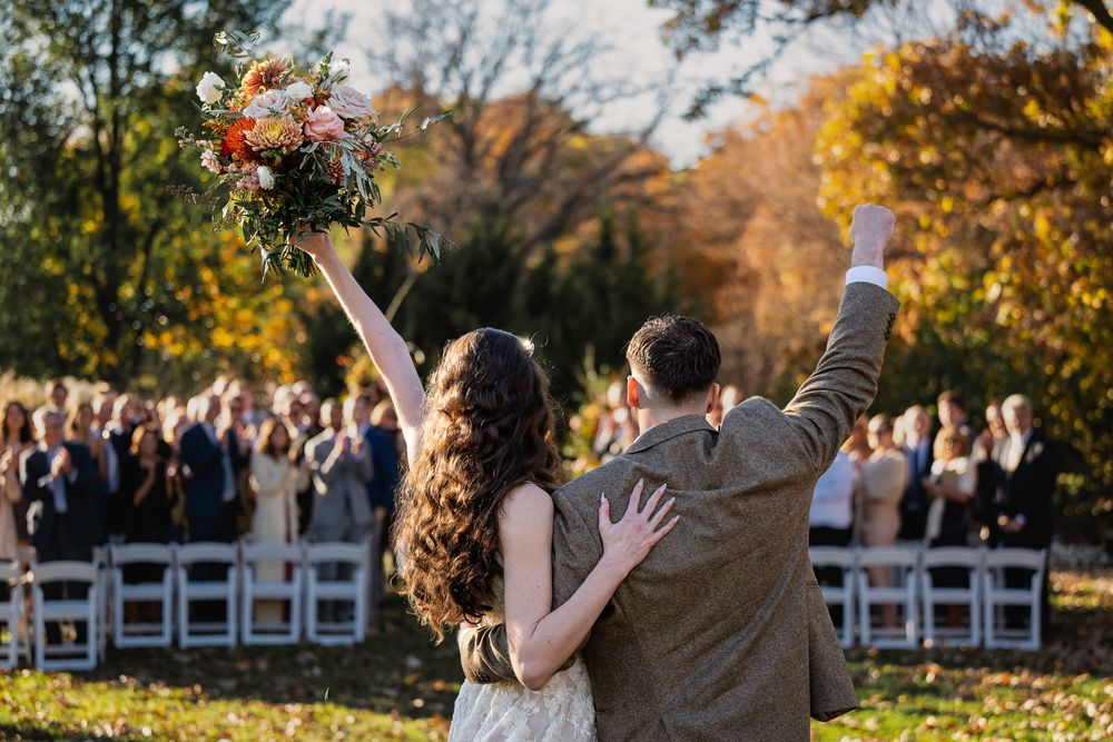bride and groom salute their guests being just married in Milwaukee