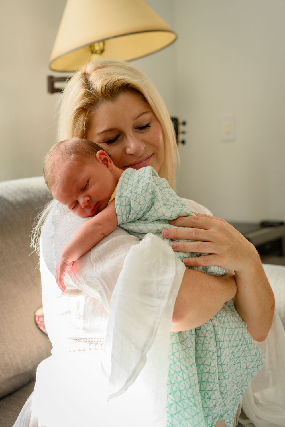 Peaceful newborn baby sleeping on mom's shoulder. Lifestyle newborn photoshoot in Las Vegas. Lifestyle Newborn photographer Las Vegas.