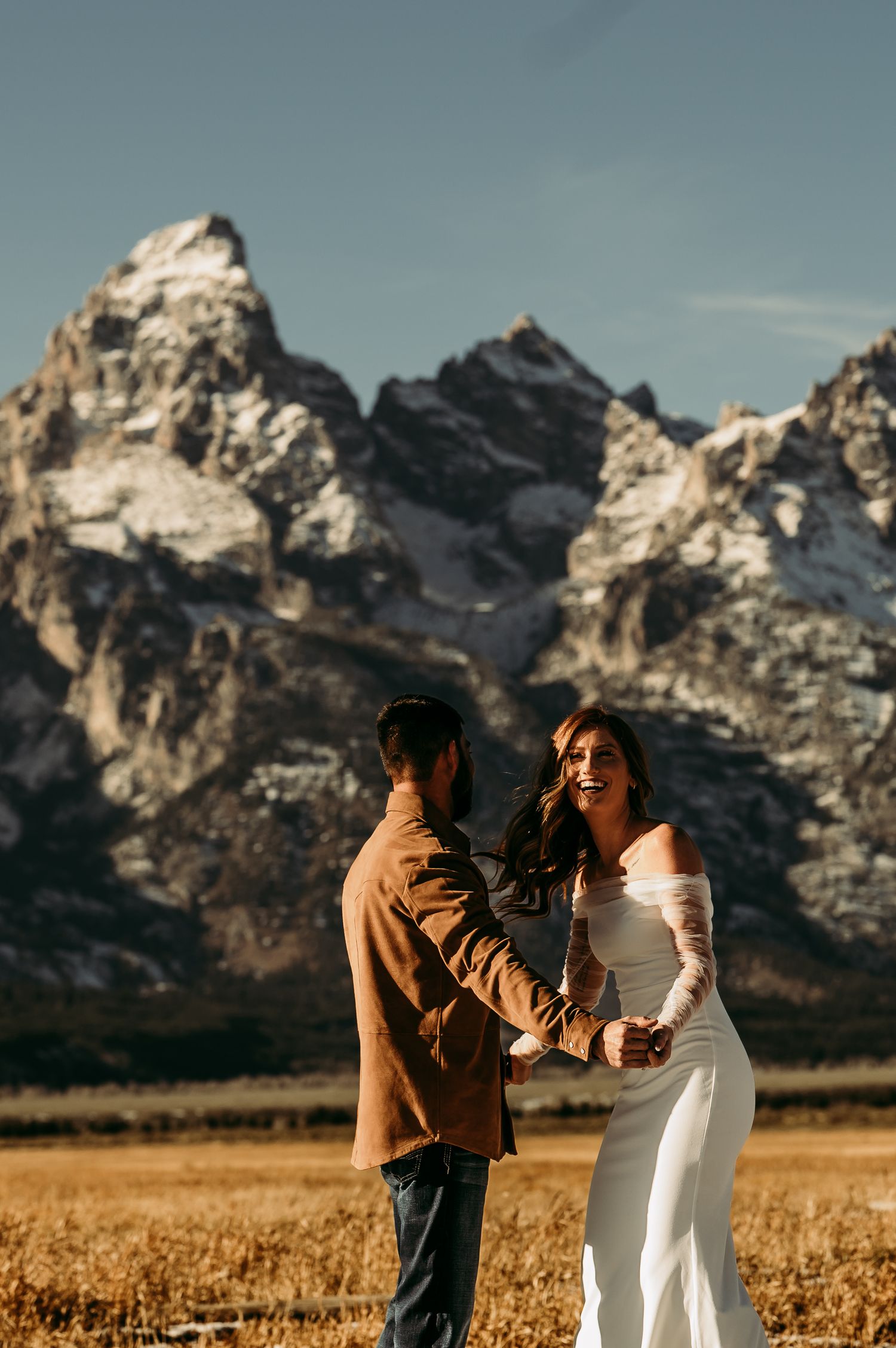 Mountain engagement session with majestic Teton peaks in background.