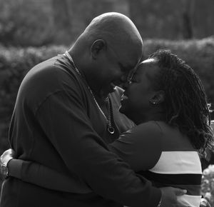 Black and white romantic portrait showing a couple sharing intimate moments together during their session with Florentina Marie Photography.