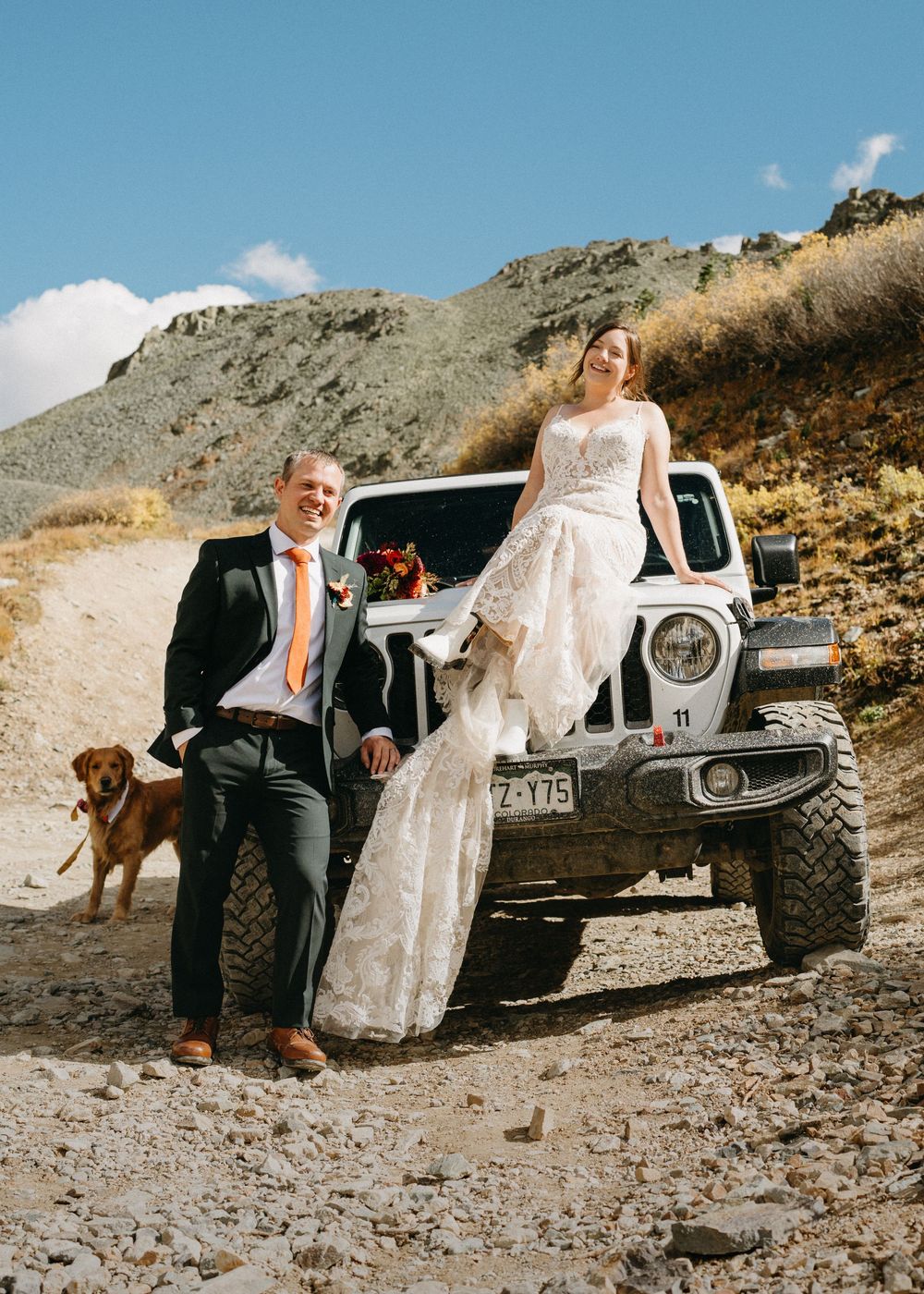 Wedding couple gathered around a white Jeep on a rocky mountain trail in Silverton, Colorado.