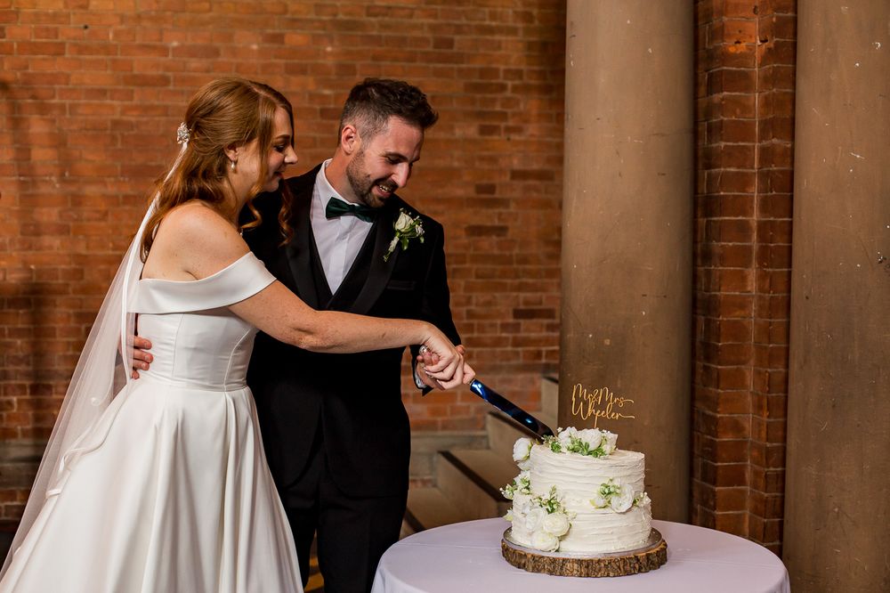 Wedding reception moments captured against brick wall backdrop with wedding cake.