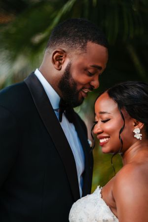 A romantic wedding moment captured between newlyweds sharing a tender smile.