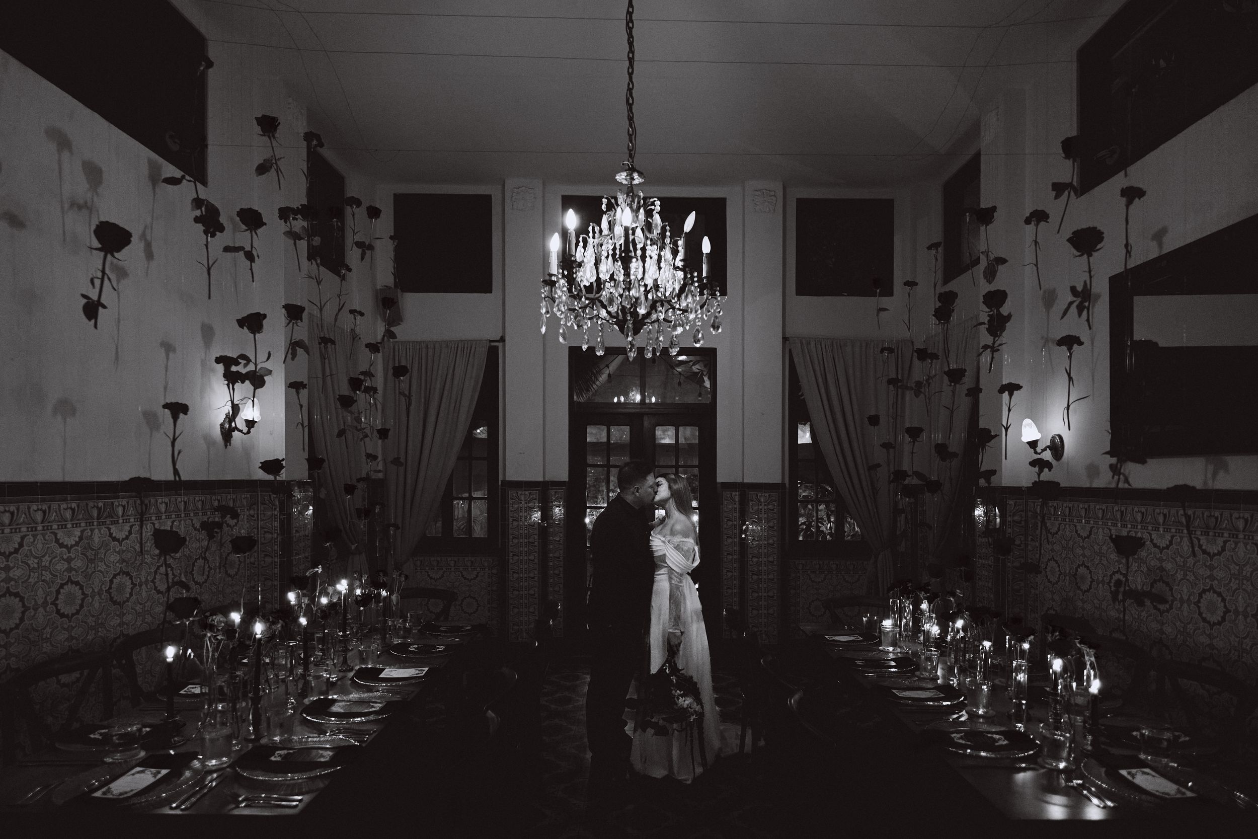 Elegant dining room decorated with hanging butterflies and crystal chandeliers creates a whimsical atmosphere.