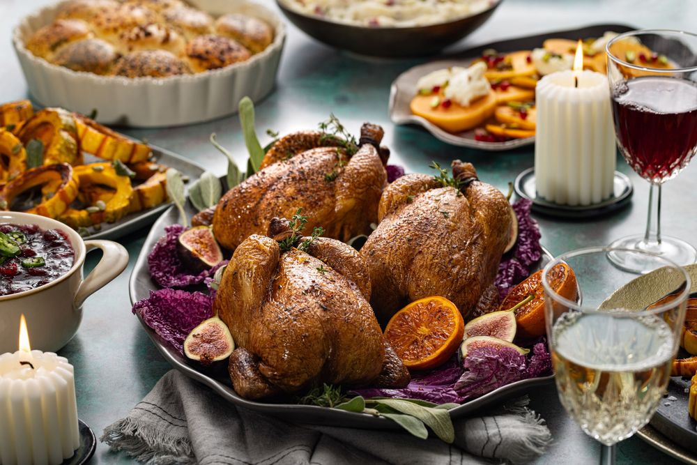 Dinner setting featuring cornish game hens served with multiple sides captured by Los Angeles food and lifestyle photographer.
