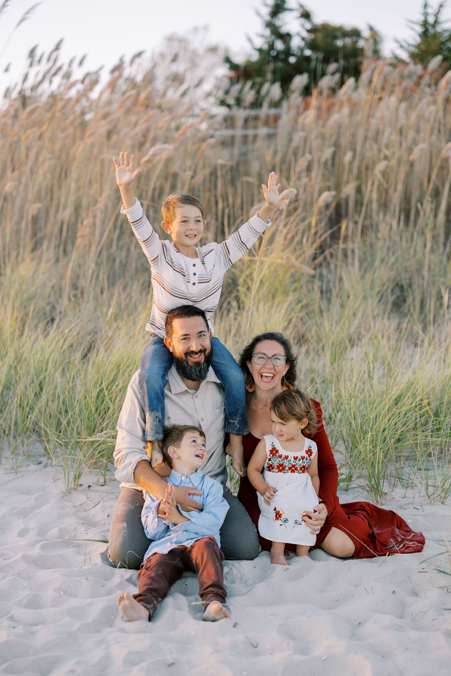 Black and white portrait of joyful family embracing outdoors.