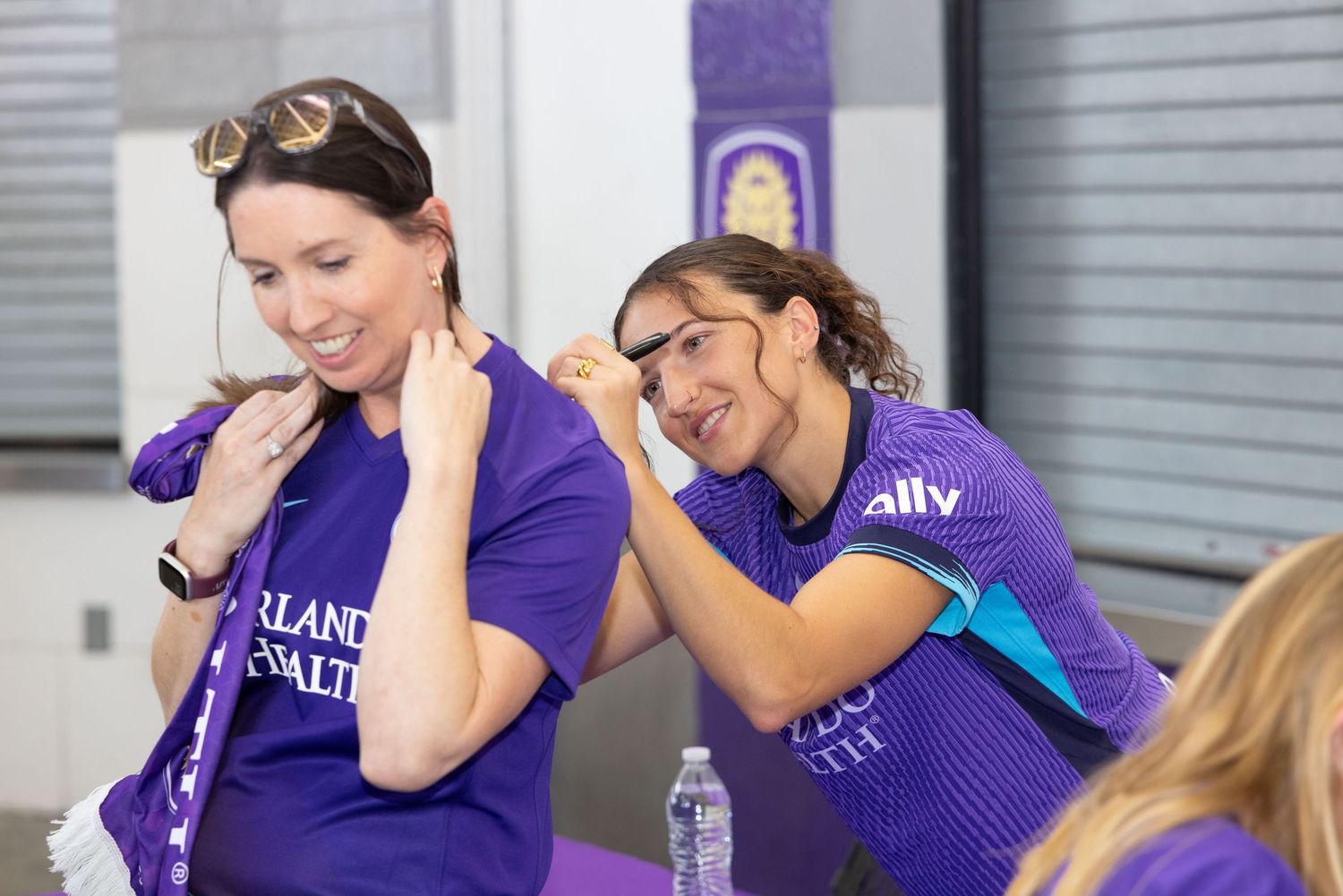Group wearing matching purple shirts celebrating at an event.