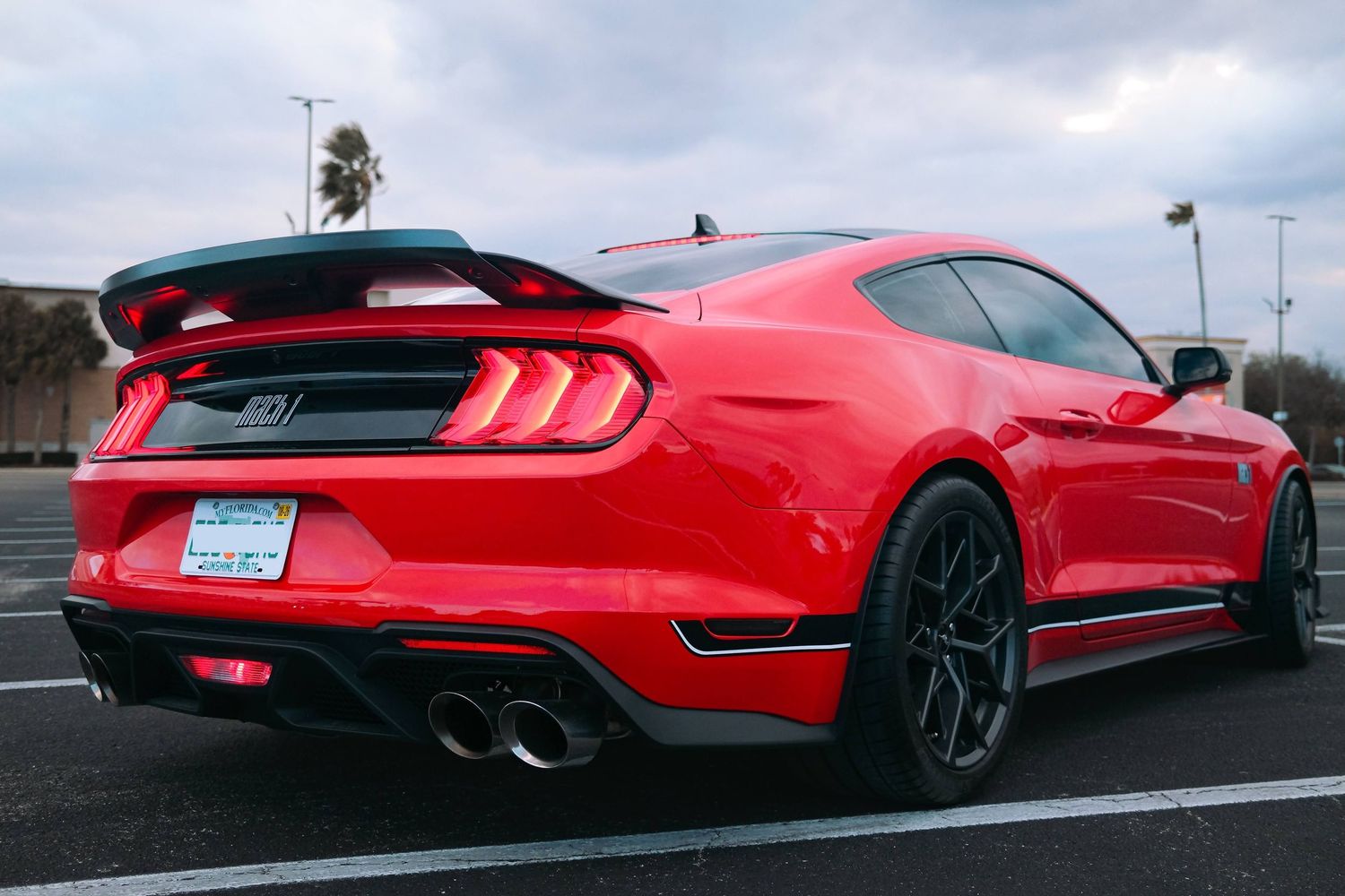 Low-angle shots of a red Ford Mustang sports car from multiple angles.