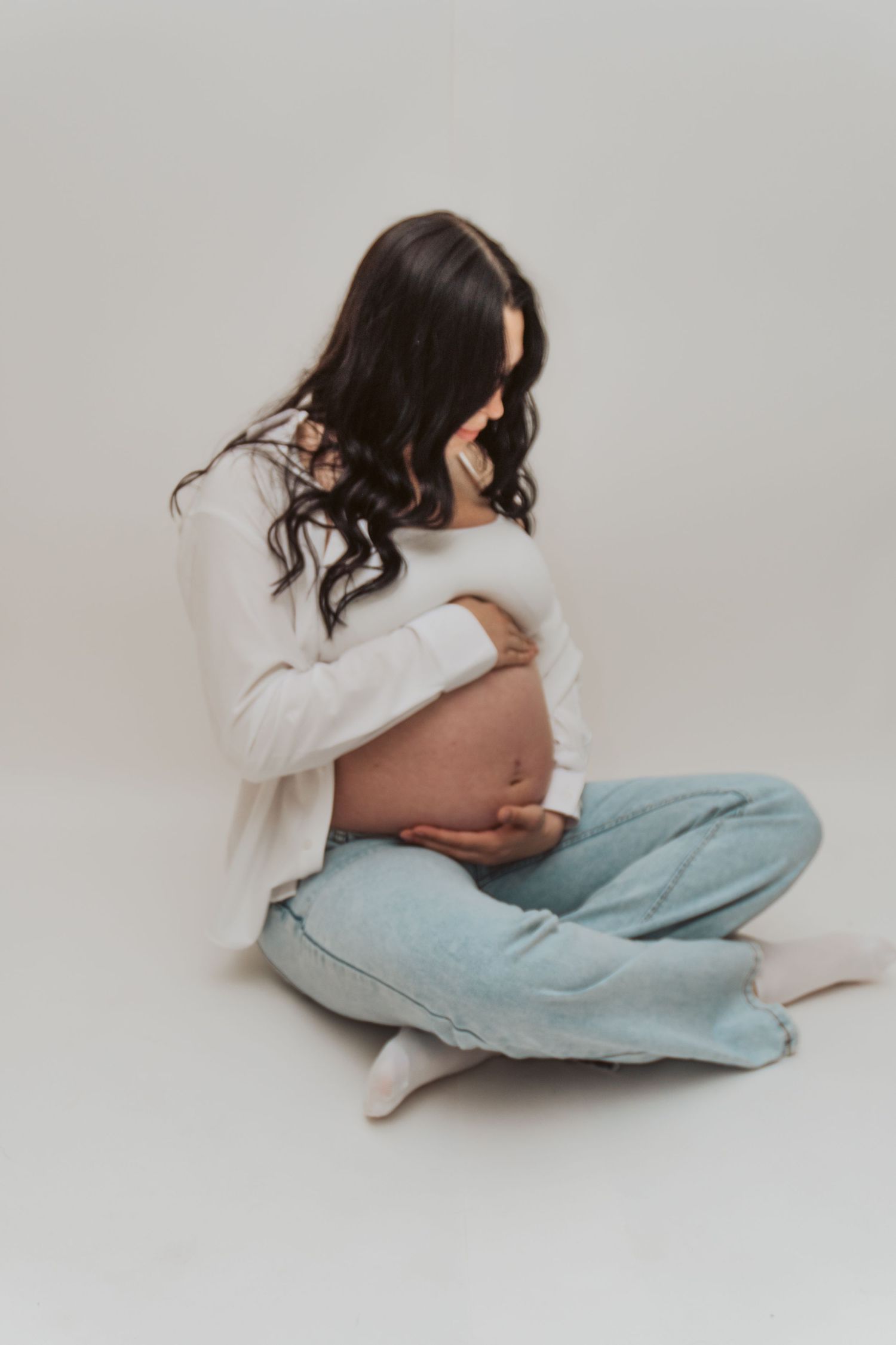 Pregnant mama studio session, holding her belly in Maine