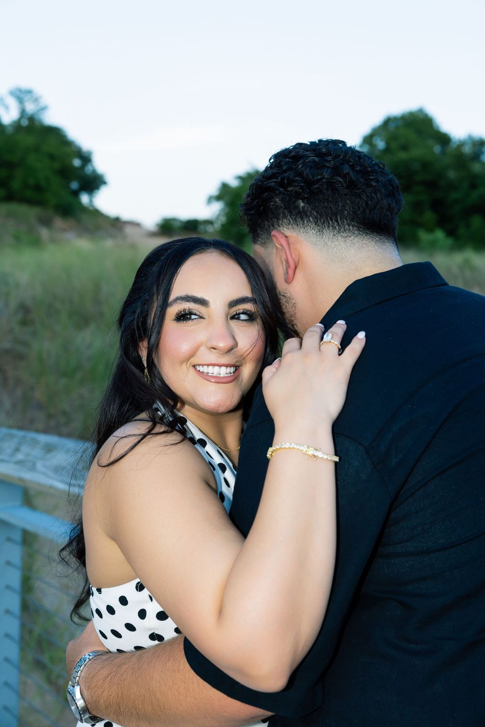 At Indiana Dunes, A romantic couple shares intimate moments outdoors in a grassy field during a photo session.