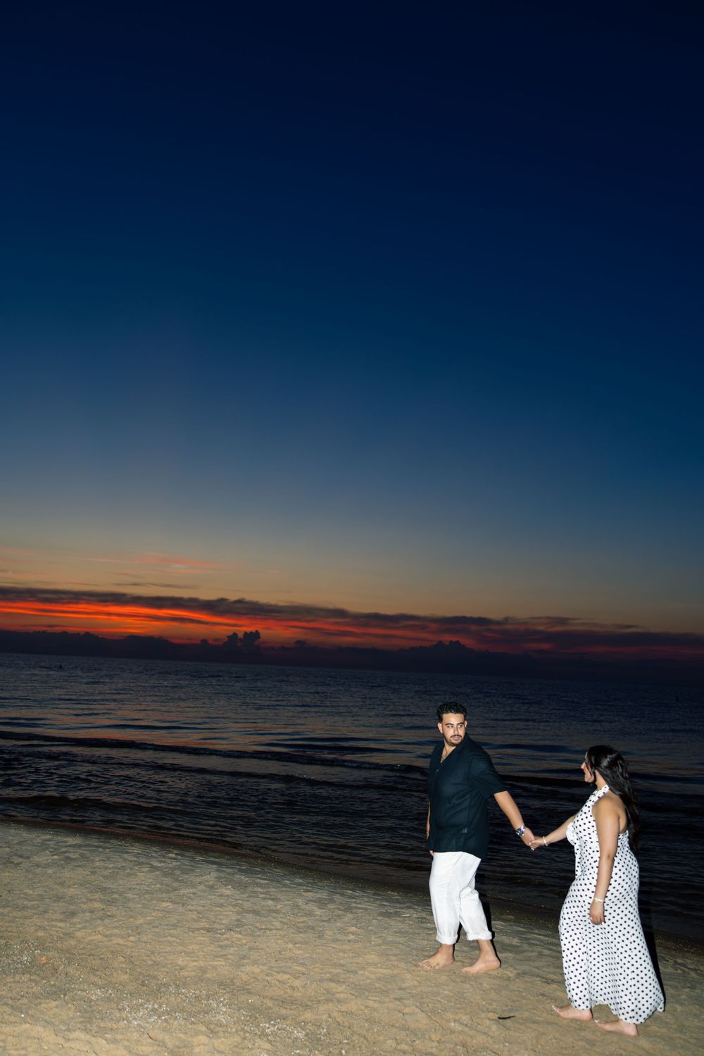 At Indiana Dunes, A scenic beach photo series showing silhouettes against a dark blue twilight sky.