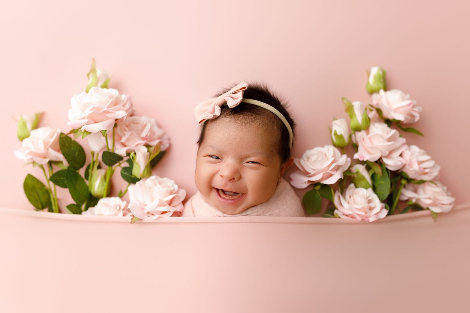 Pink apple blossoms create a delicate floral border frame against a soft pink background.