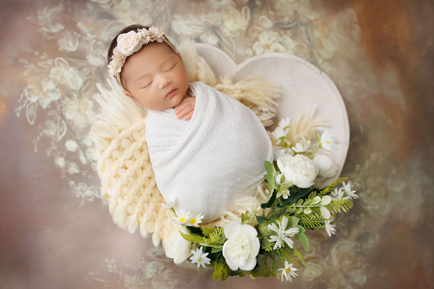 A delicate white floral crown rests on a soft textured background with gentle lighting and dreamy atmosphere.