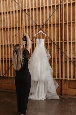Wedding dress display on wooden wall in venue. The Paseo, Apache Junction, AZ wedding venue.