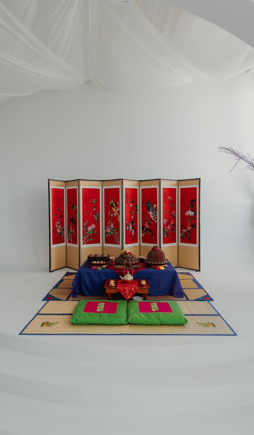 A series of photos showing decorative red and gold folding screens with teddy bears arranged in traditional Asian settings.
