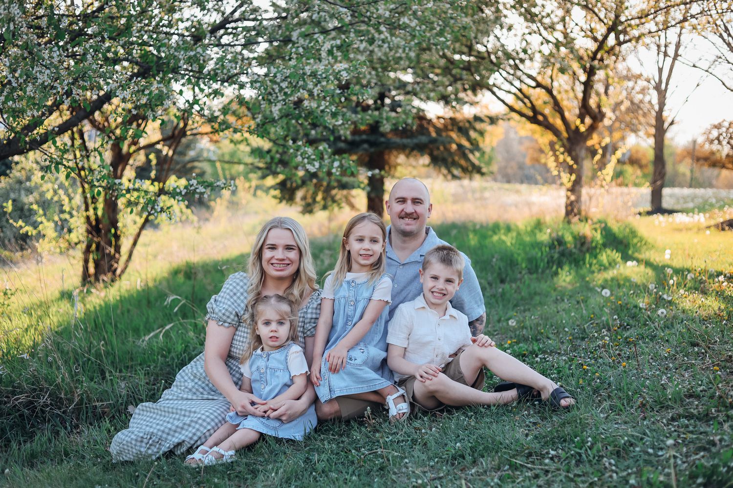 Extended family portrait in winter setting with snow-covered field and mountains in background. Extended family photography