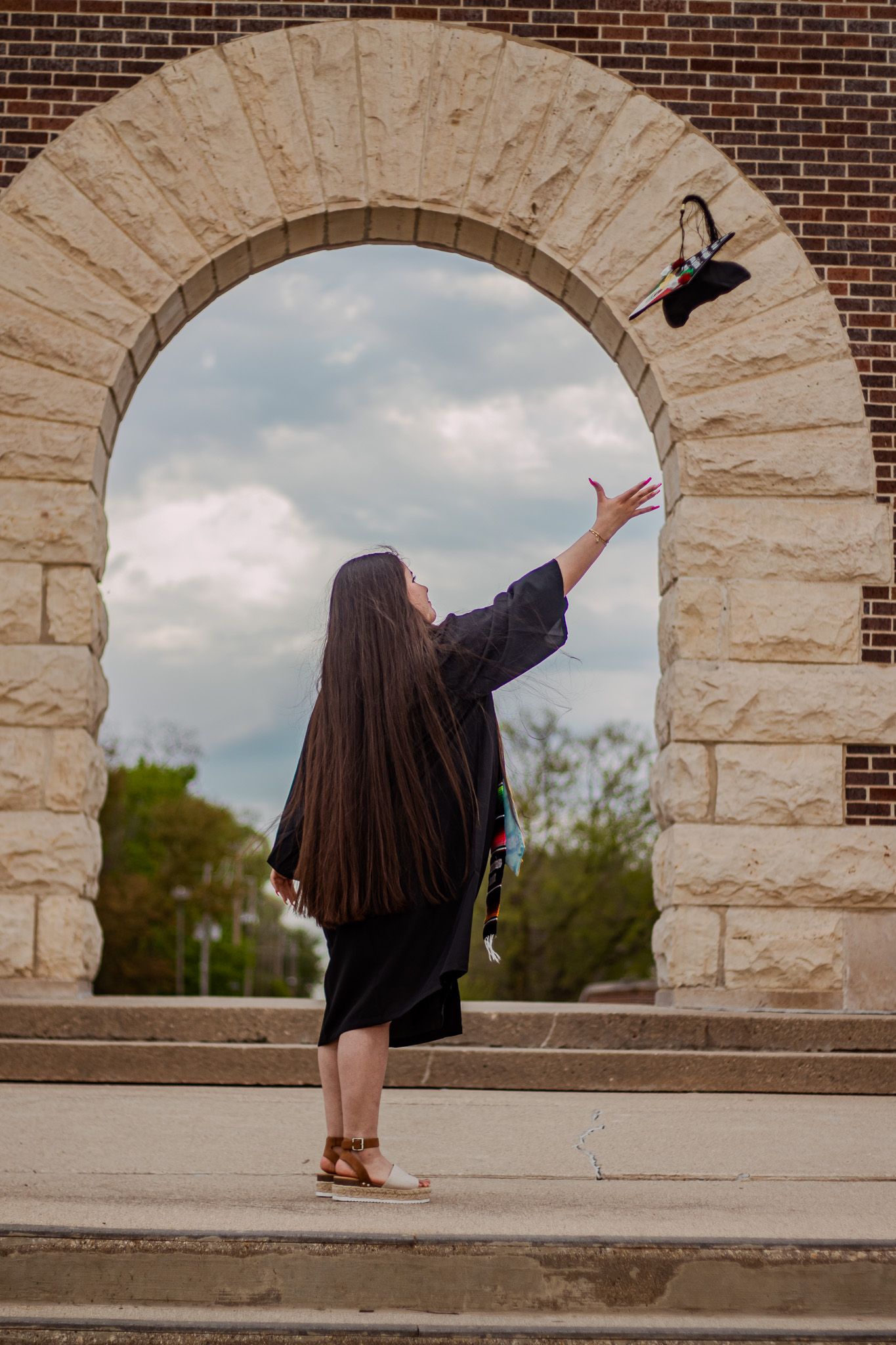 Graduate throwing her cap at Buena Vista University.