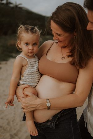 Tender family moments captured in a series of intimate beach portraits at sunset.