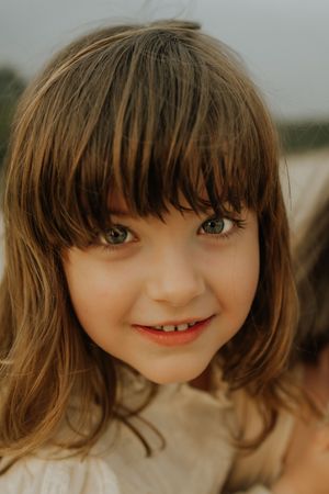 A close-up sequence of a doll's face with brown bangs and a sweet smile shown from different angles.