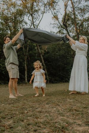 A series of candid outdoor photos showing joyful dancing and movement in a natural setting during golden hour.