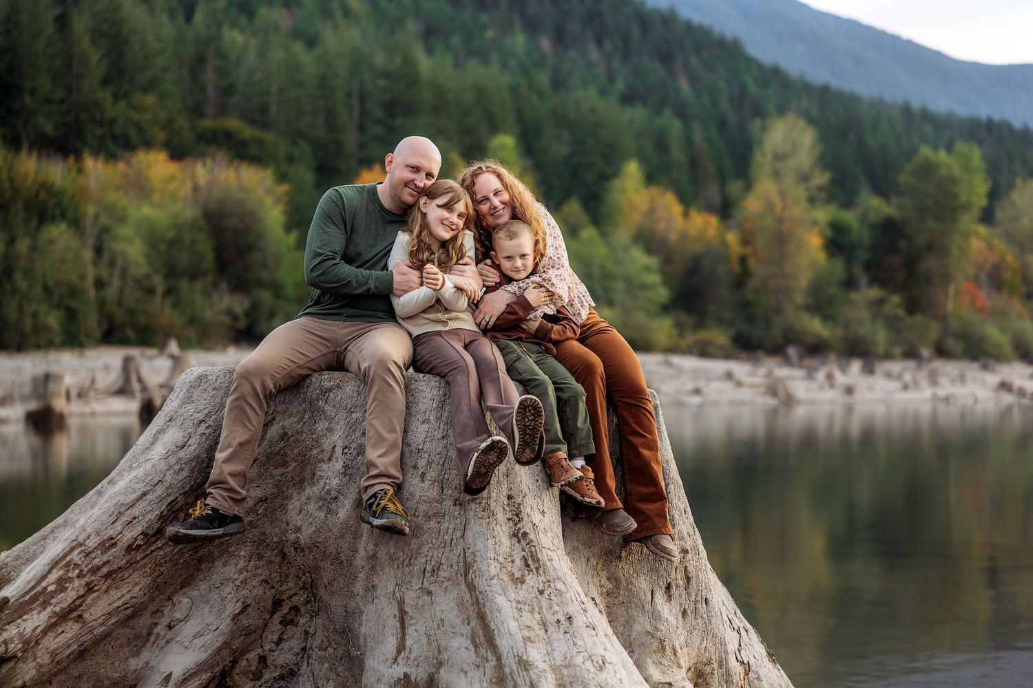 Pine + Vow with husband and two kids sitting down on a tree stump