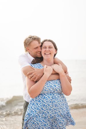 A Couple embracing on the beach