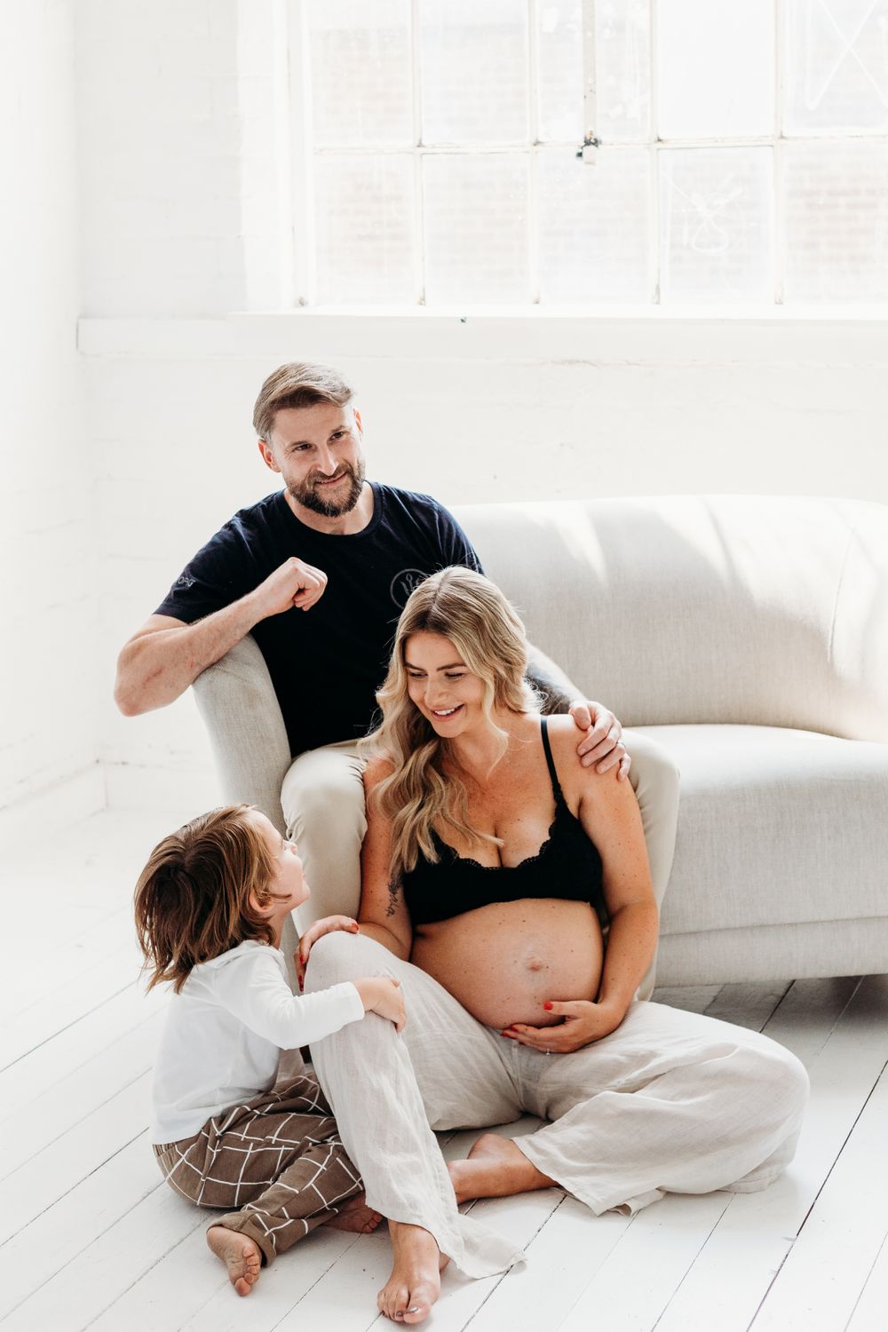 Pregnant mum with husband and son family photographed in Mapperley studio in Nottingham for a candid maternity photoshoot
