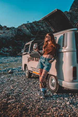 A series of lifestyle photos featuring a Rimor Bay scooter on a rocky beach shore during sunset with orange tinted lighting.