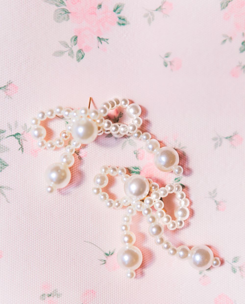Close-up of an elegant wedding invitation suite and bridal jewelry, showcasing custom designs for a timeless wedding