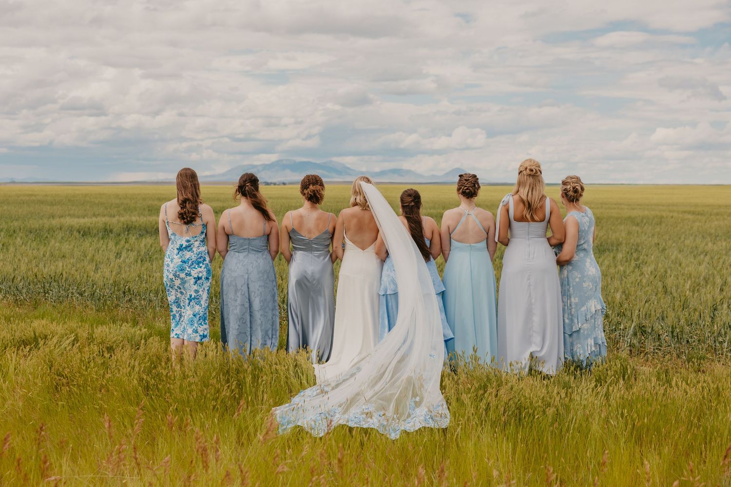 Montana Bride and bridesmaids looking out at the Sweet Grass Hills captured by Montana Wedding Photographer. Paradise Valley Wedding