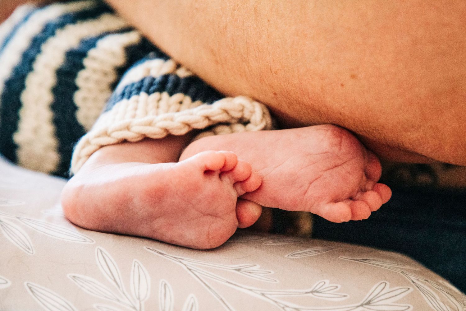 Close-up of small baby feet against a white background.