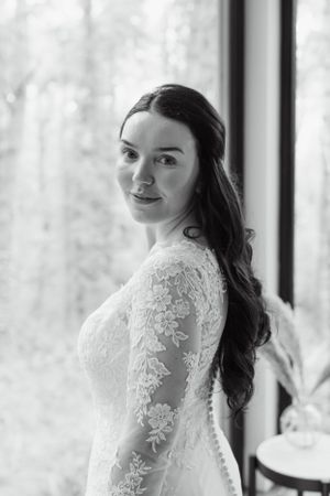 Elegant lace wedding dress details captured in natural window light.