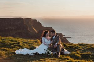 Sunset wedding photography session on dramatic coastal cliffs with golden hour lighting.