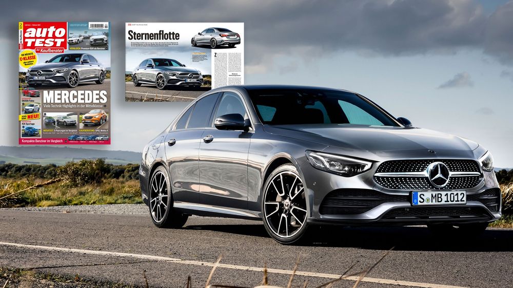 Modern silver Mercedes-Benz CLS sports car parked on a hill with dramatic cloudy sky and auto magazine cover in background.
